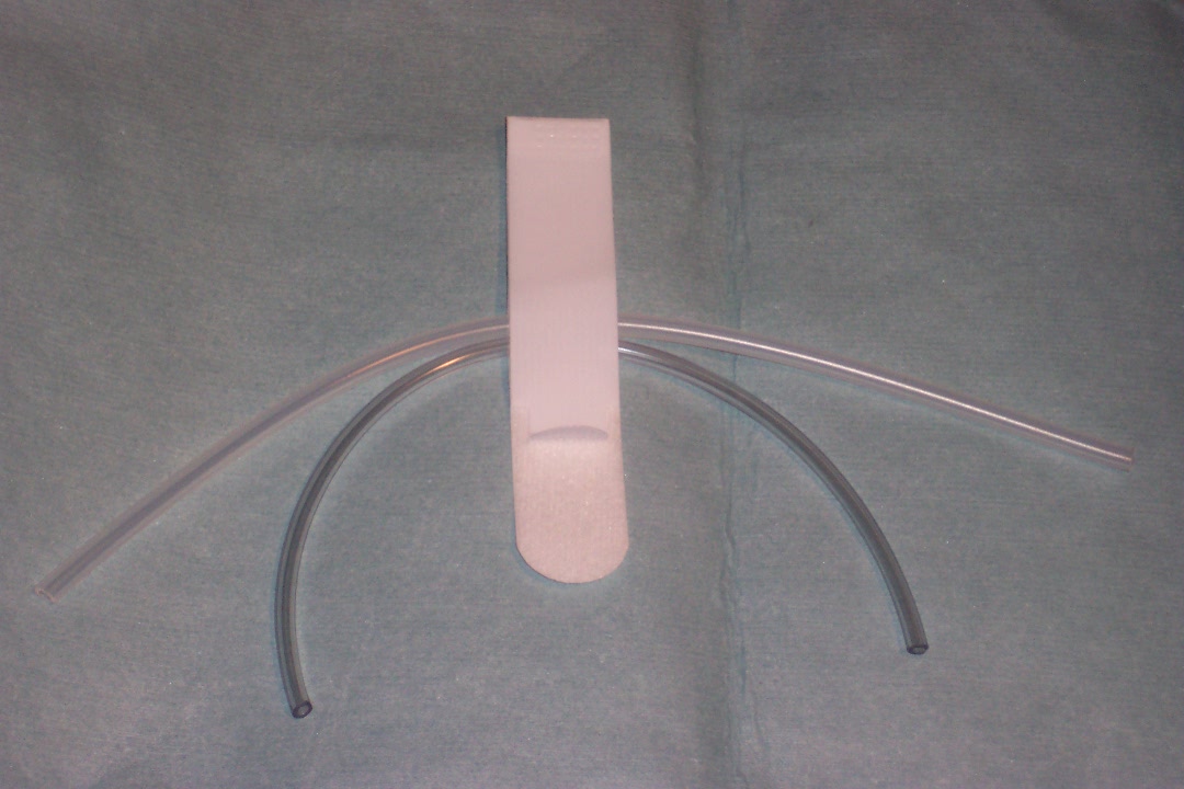 Hook and loop tab style tubing holder